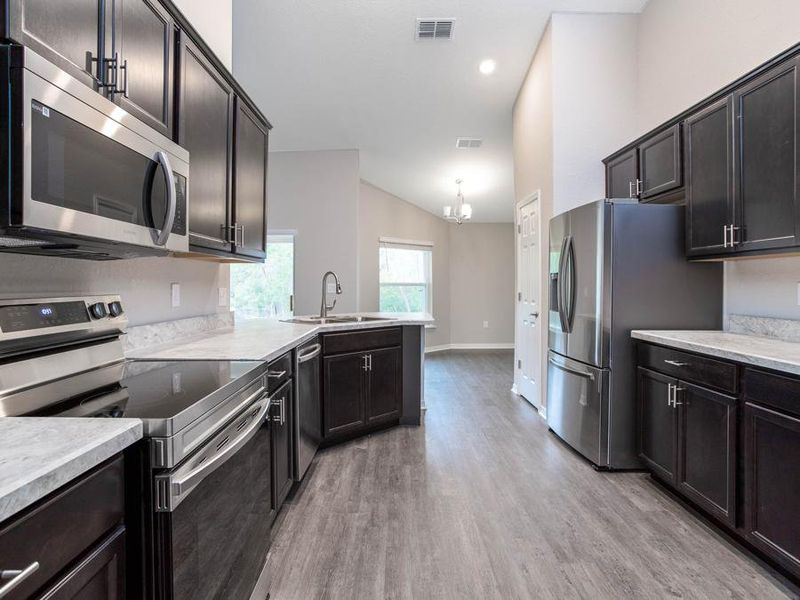 Your new kitchen includes beautiful finishes and is open to the dining cafe - New home for sale in  Winter Haven, FL