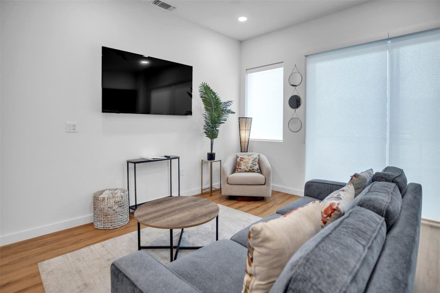 Living room featuring recessed lighting, baseboards, and wood finished floors