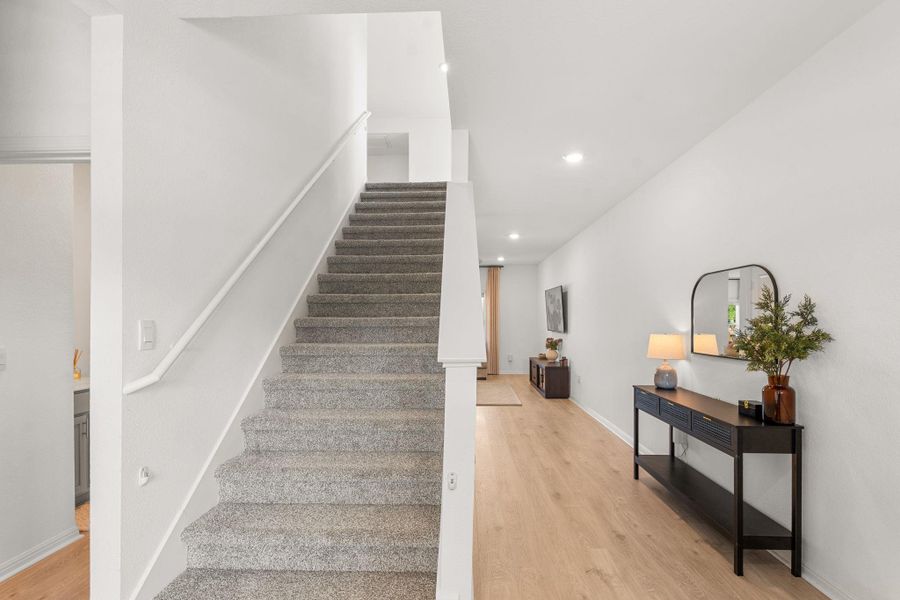 Entry hallway, guest bedroom to the left, hallway leading to living room to the right Entry hallway, guest bedroom to the left, hallway leading to living room to the right