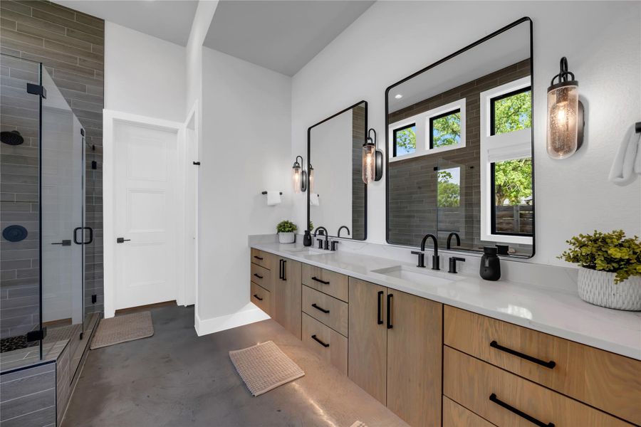 Dual wood-finish vanity with integrated sinks, black hardware, and quartz countertops