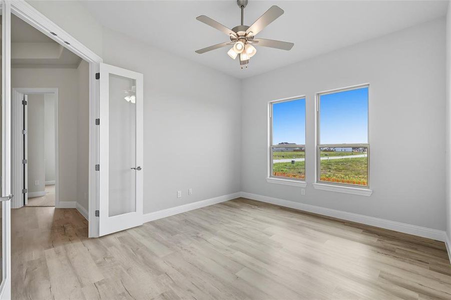 Spare room featuring light wood-style flooring and ceiling fan Spare room featuring light wood-style flooring and ceiling fan