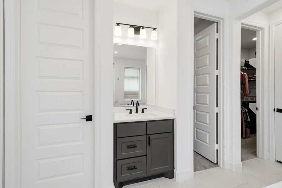 The primary bath features dual vanity with abundant storage. As a bonus, there is ample space, with two walk-in closets to keep everything beautifully organized.
