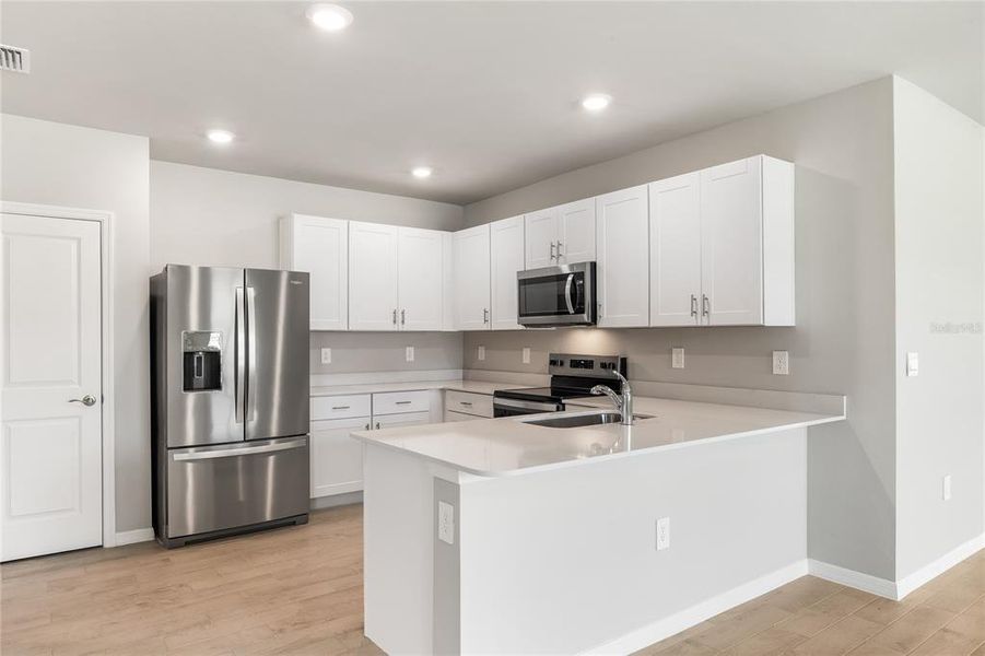 Furnished interior view inside a new home in Cove at West Port - Tradition, Port Charlotte (Image 12).