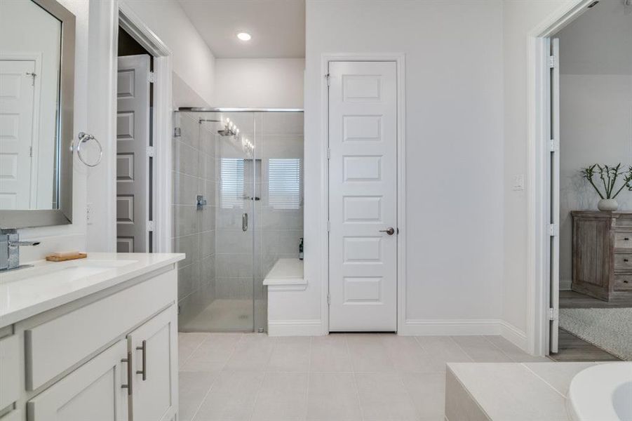 Full bathroom with tile patterned floors, a stall shower, baseboards, recessed lighting, and vanity Full bathroom with tile patterned floors, a stall shower, baseboards, recessed lighting, and vanity