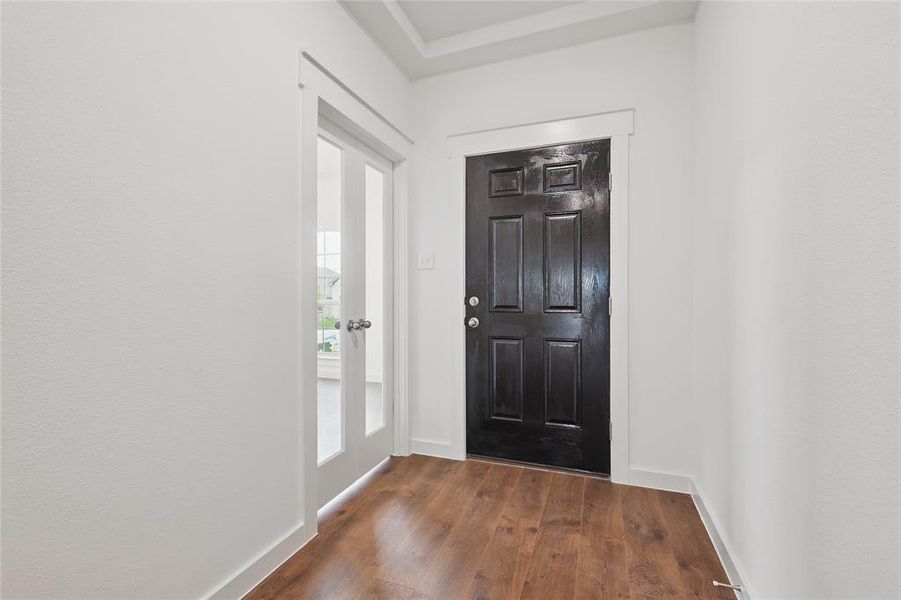 Foyer entrance with dark wood finished floors and baseboards Foyer entrance with dark wood finished floors and baseboards