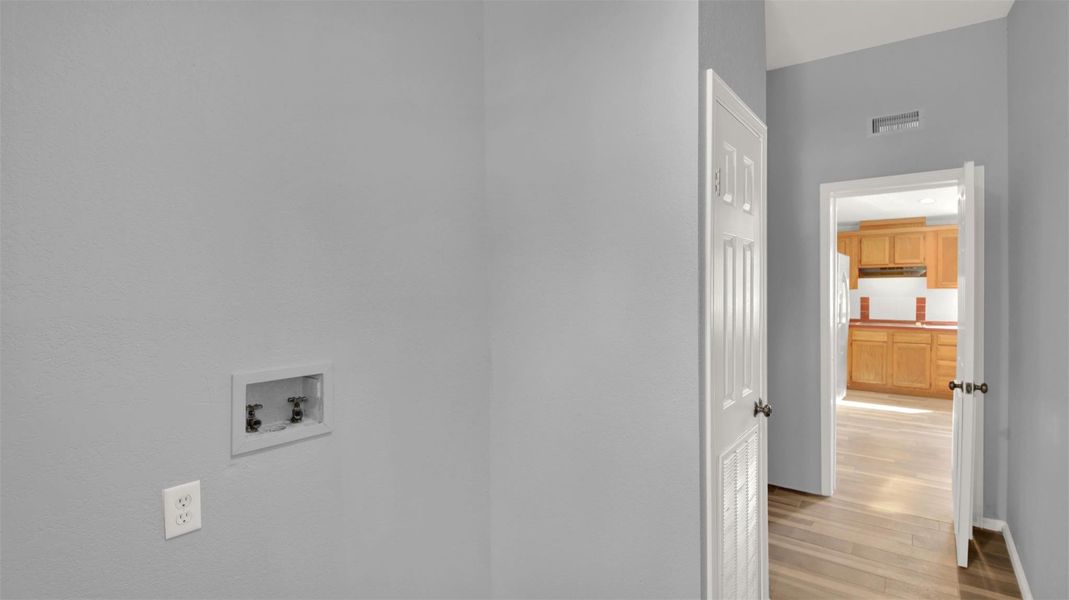 Laundry room featuring hookup for a washing machine and light wood-type flooring