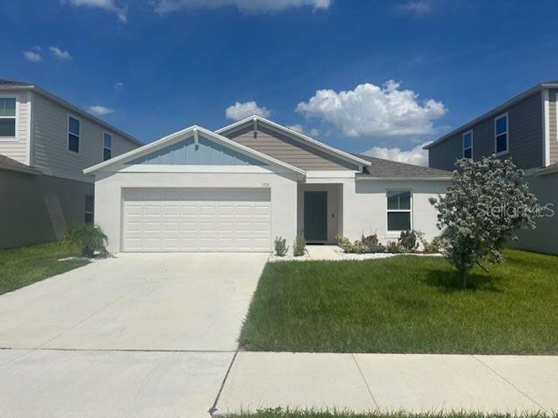 Front exterior of a new home in Pinnacle Point, Winter Haven, FL, highlighting curb appeal (Image 1). Front exterior of a new home in Pinnacle Point, Winter Haven, FL, highlighting curb appeal (Image 1).
