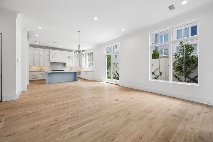 The stunning first floor was designed with relaxation and entertaining in mind! Spacious enough for ampleseating surrounding the fireplace, a large dining table, and an island with additional seating that overlooks the living space.