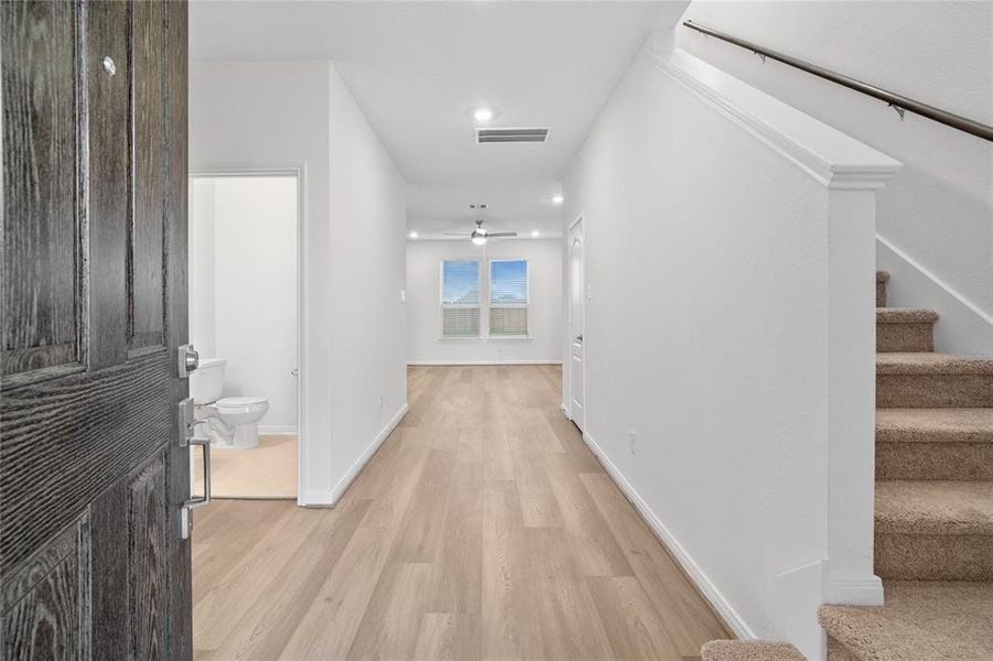 Welcome to your new home at 8114 Shelter Bay. You are greeted with this beautiful entryway featuring vinyl plank flooring and custom paint.