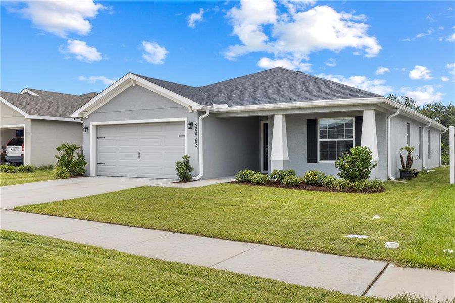 Front exterior of a new home in Stonebridge North, Zephyrhills, FL, highlighting curb appeal (Image 22). Front exterior of a new home in Stonebridge North, Zephyrhills, FL, highlighting curb appeal (Image 22).