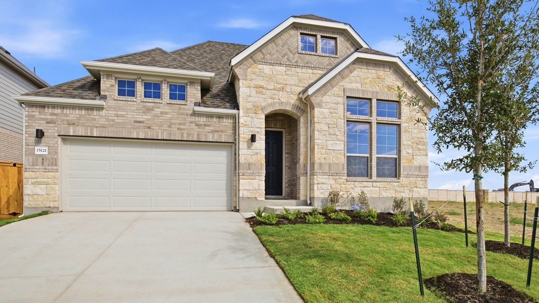 Front exterior of a new home in Newhaven, Manor, TX, highlighting curb appeal (Image 21). Front exterior of a new home in Newhaven, Manor, TX, highlighting curb appeal (Image 21).