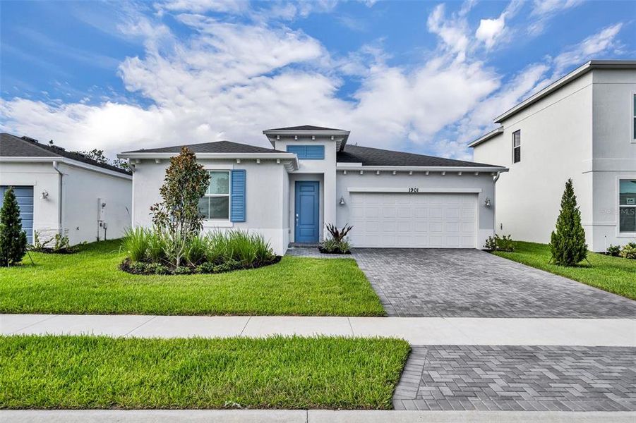 Front exterior of a new home in Riverwood at Everlands: The Angler Collection, Palm Bay, FL, highlighting curb appeal (Image 1). Front exterior of a new home in Riverwood at Everlands: The Angler Collection, Palm Bay, FL, highlighting curb appeal (Image 1).