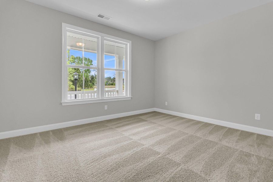 Spacious, unfurnished interior of a new home in Tidewater at Lakes of Cane Bay, Summerville (Image 22).