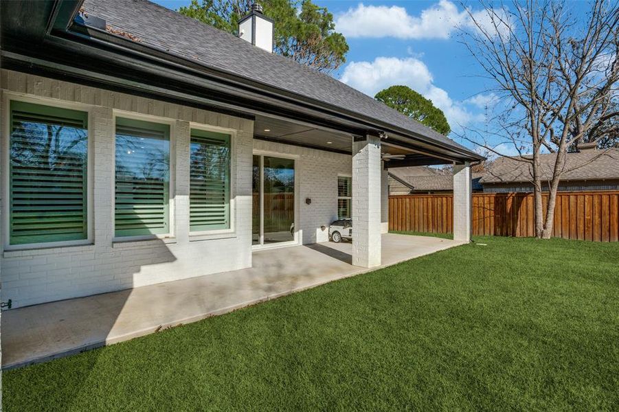 Back of house featuring a patio and a lawn