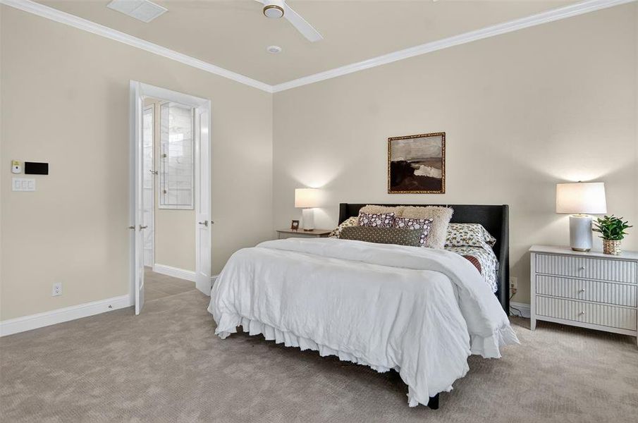 Bedroom with ornamental molding, carpet floors, and ceiling fan