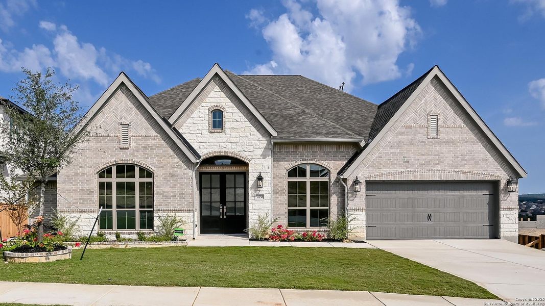 Front exterior of a new home in Johnson Ranch 70', Bulverde, TX, highlighting curb appeal (Image 21). Front exterior of a new home in Johnson Ranch 70', Bulverde, TX, highlighting curb appeal (Image 21).