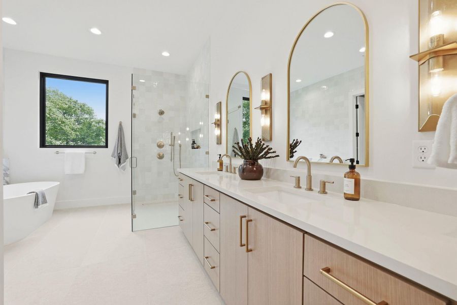 Dual vanity with light wood-finish cabinetry and gold-tone hardware
