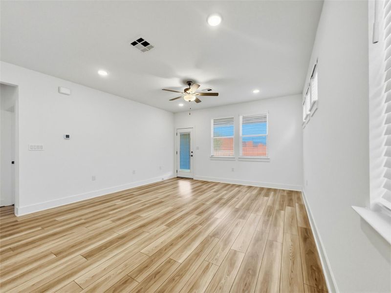 Living room with light wood-style floors, recessed lighting, and a ceiling fan