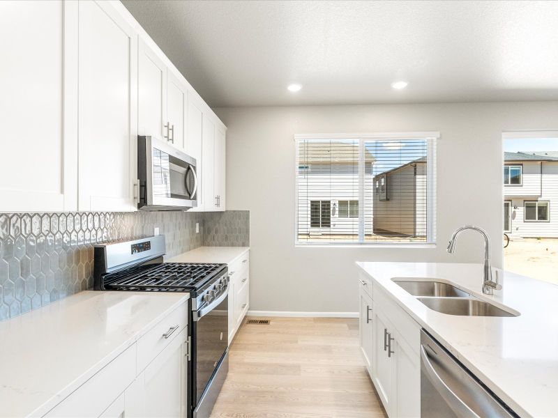 Kitchen in the Wateron floorplan at a Meritage Homes community in Brighton, CO.