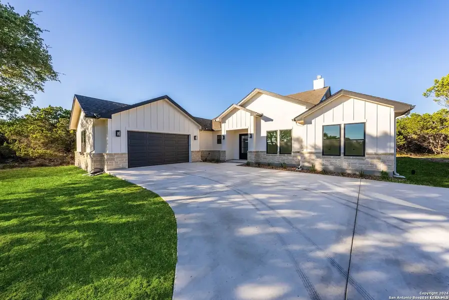 Front exterior of a new home in , Bandera, TX, highlighting curb appeal (Image 26).