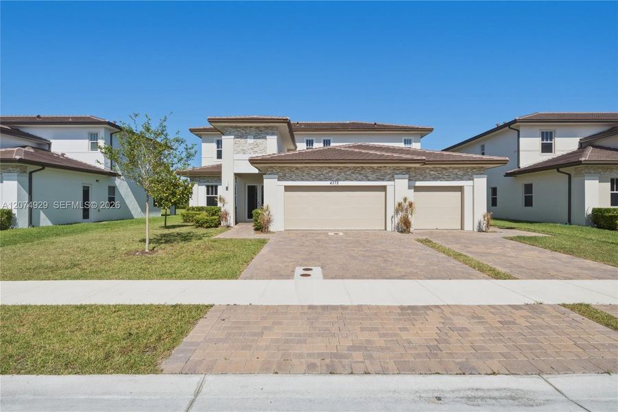 Front exterior of a new home in , Davie, FL, highlighting curb appeal (Image 1). Front exterior of a new home in , Davie, FL, highlighting curb appeal (Image 1).