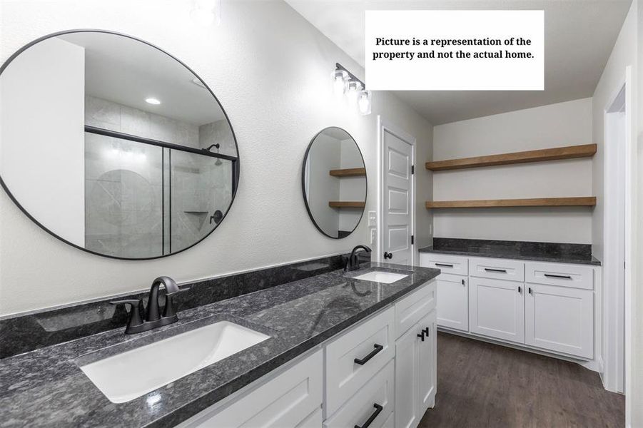Double vanity featuring integrated rectangular sinks, dark countertops, and matte black fixtures