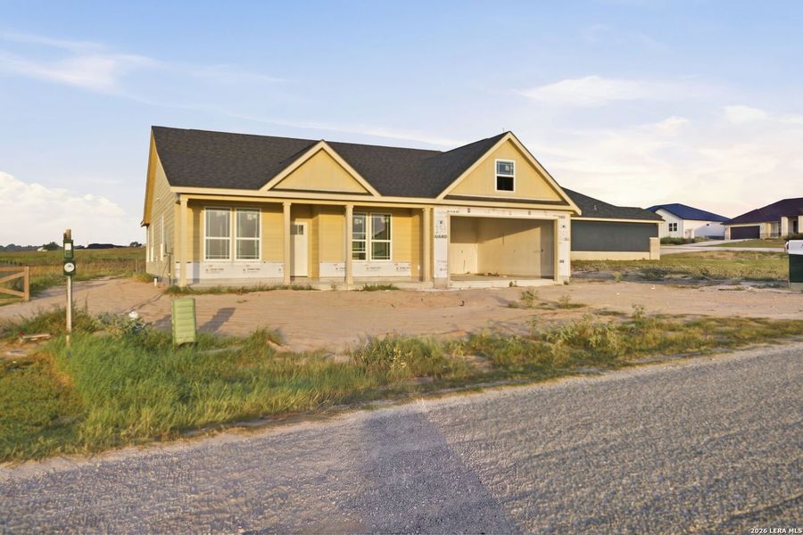Front exterior of a new home in Las Palomas Country Club Estates, La Vernia, TX, highlighting curb appeal (Image 1). Front exterior of a new home in Las Palomas Country Club Estates, La Vernia, TX, highlighting curb appeal (Image 1).
