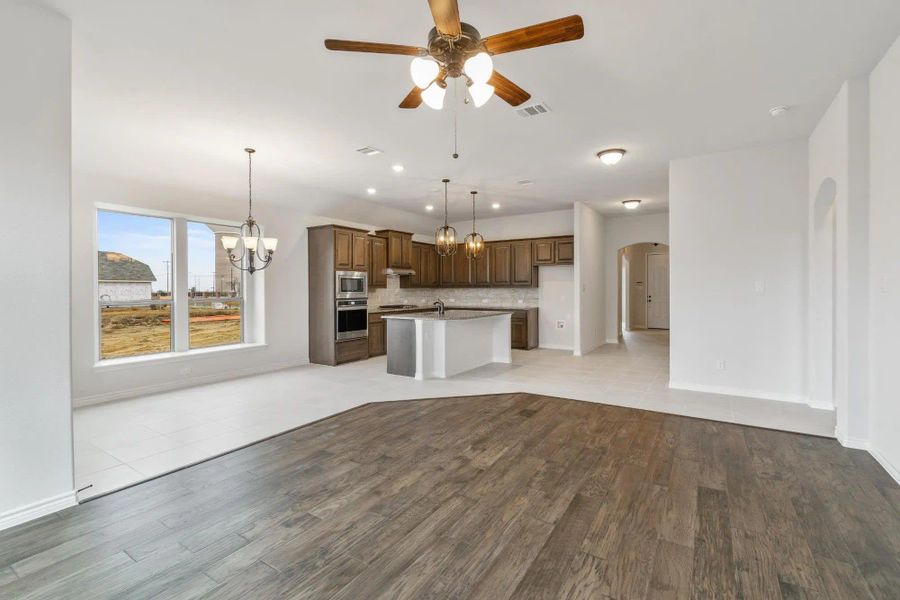 Family Room & Kitchen | Concept 1841 at Coyote Crossing in Godley, TX by Landsea Homes