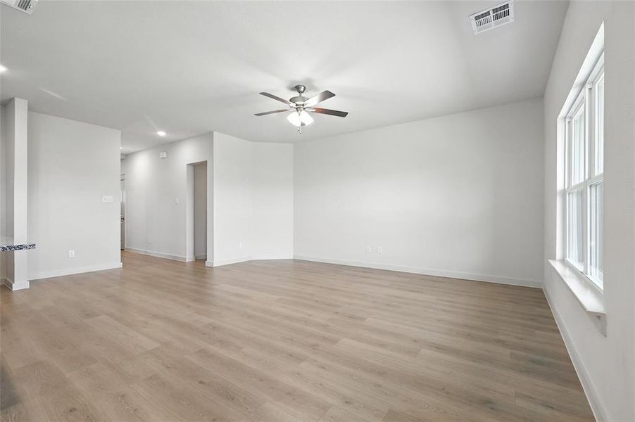Unfurnished room featuring light wood-style floors, a ceiling fan, and recessed lighting Unfurnished room featuring light wood-style floors, a ceiling fan, and recessed lighting