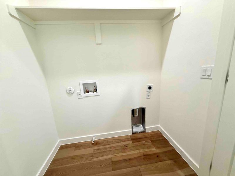 Washroom featuring washer hookup, dark wood finished floors, gas dryer hookup, and hookup for an electric dryer