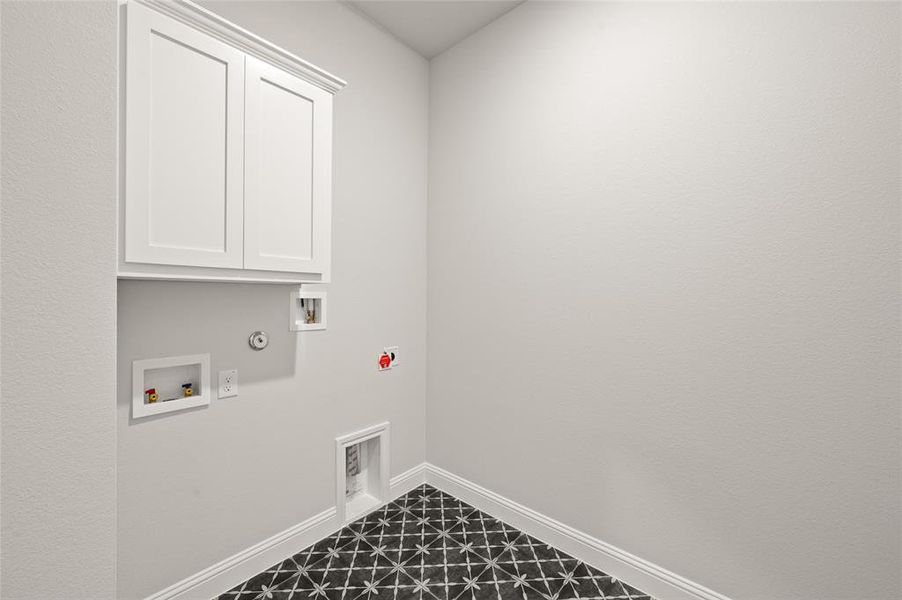 Laundry area featuring hookup for a washing machine, gas dryer hookup, and cabinet space
