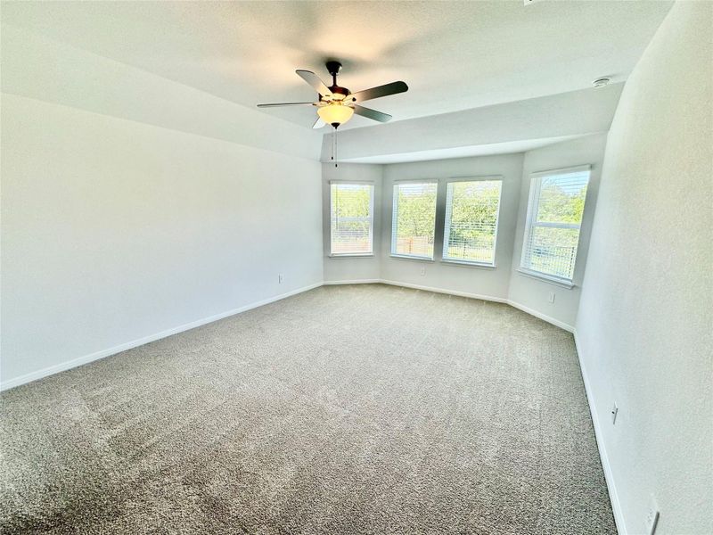 Unfurnished room featuring carpet floors, ceiling fan, and a textured ceiling Unfurnished room featuring carpet floors, ceiling fan, and a textured ceiling