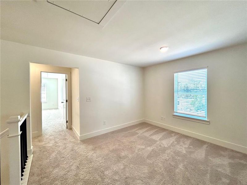 Empty room featuring light colored carpet