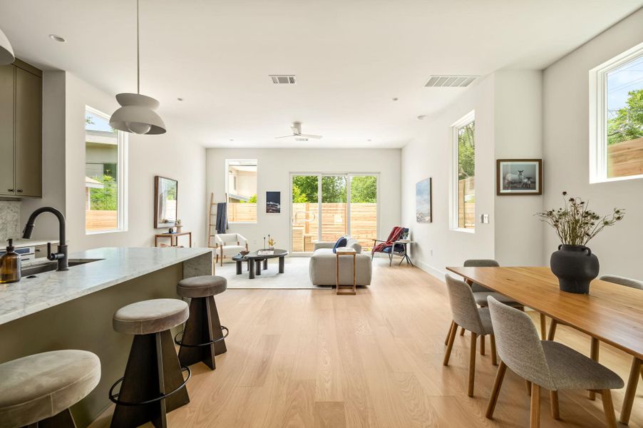 Clean lines and natural light define this inviting open-concept living and dining space.