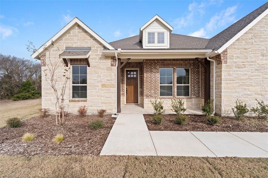Front exterior of a new home in Nash Estates, Tom Bean, TX, highlighting curb appeal (Image 26). Front exterior of a new home in Nash Estates, Tom Bean, TX, highlighting curb appeal (Image 26).