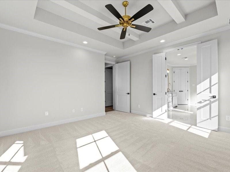 Unfurnished bedroom with recessed lighting, a tray ceiling, crown molding, light colored carpet, and a ceiling fan Unfurnished bedroom with recessed lighting, a tray ceiling, crown molding, light colored carpet, and a ceiling fan