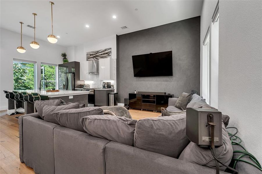 Living room with light wood-style flooring and recessed lighting Living room with light wood-style flooring and recessed lighting