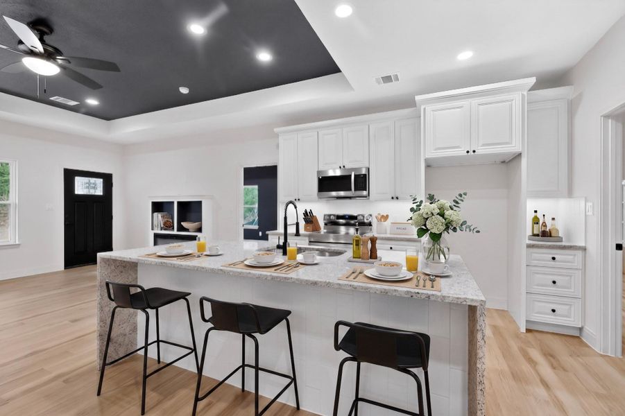 Modern kitchen island with granite countertops and white paneling Modern kitchen island with granite countertops and white paneling