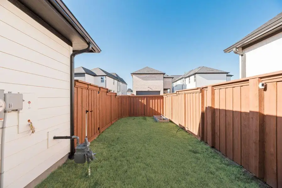 Fenced backyard featuring a residential view