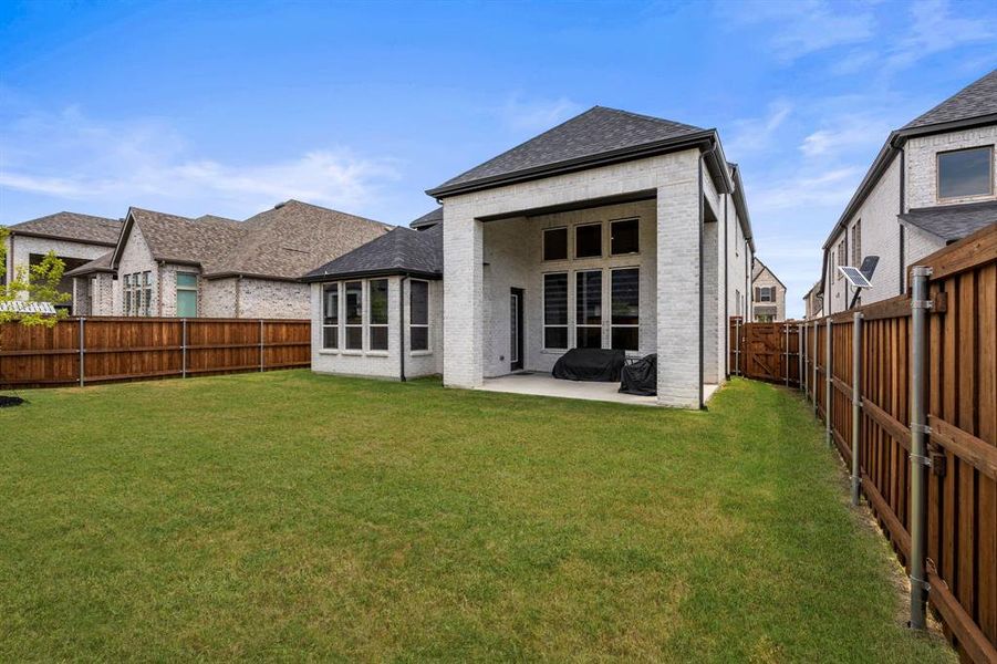 Rear view of property featuring a patio area and a fenced backyard Rear view of property featuring a patio area and a fenced backyard