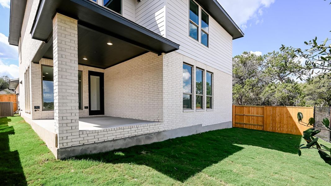 Rear view of house with a patio area and brick siding Rear view of house with a patio area and brick siding