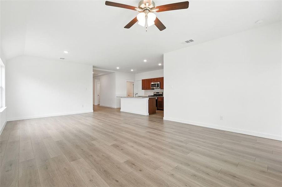 Unfurnished living room featuring recessed lighting, ceiling fan, and light wood-type flooring
