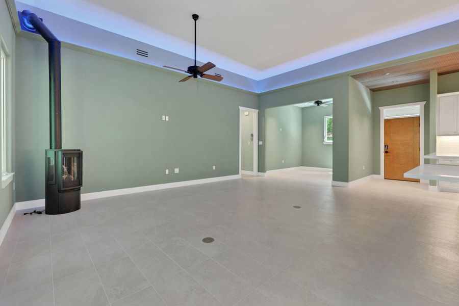 The living area features a freestanding wood-burning stove, designed for cozy gatherings.