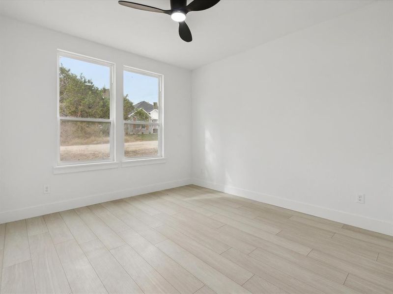 Spare room featuring ceiling fan and light hardwood / wood-style floors