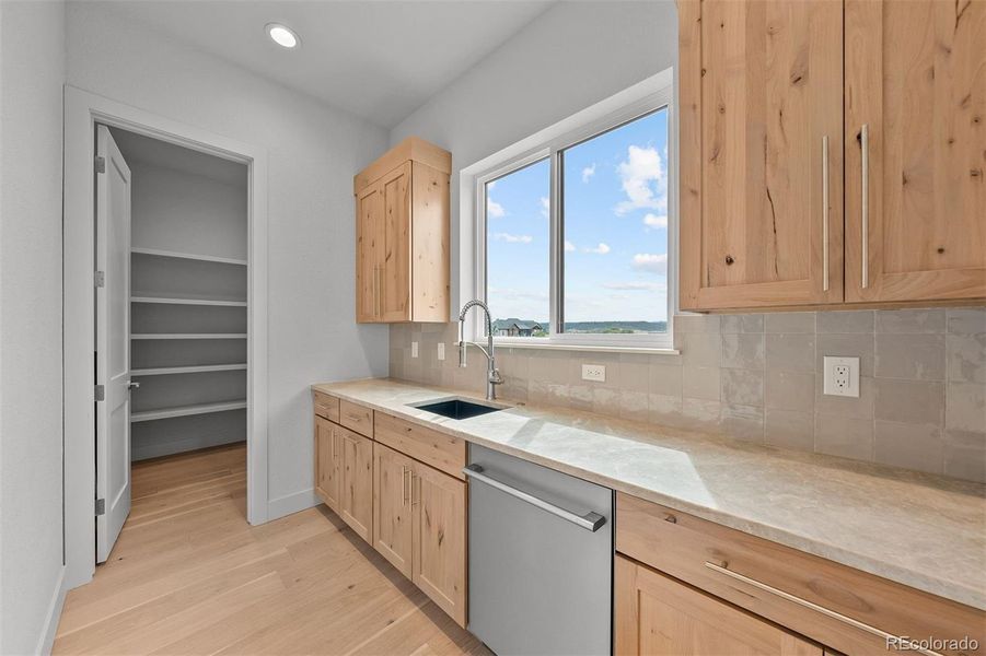 Back kitchen with secondary dishwasher and sink, plus a walk-in pantry.