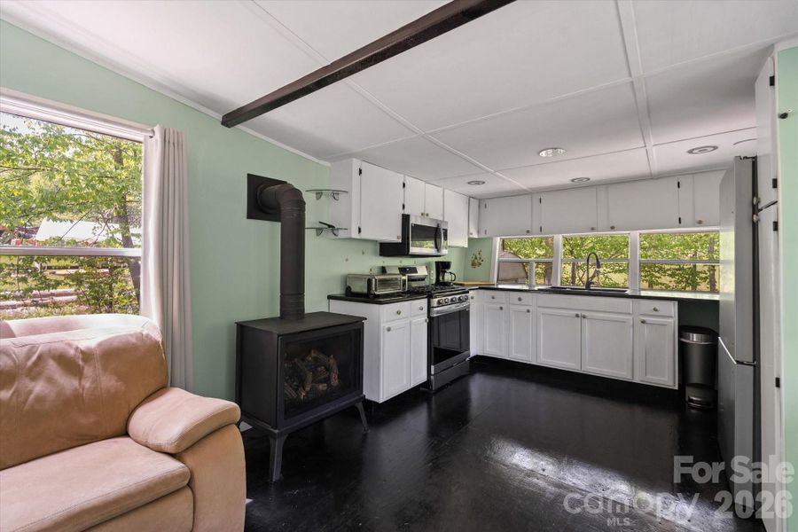 Gas logs give cozy heat to the main space in the winter months.