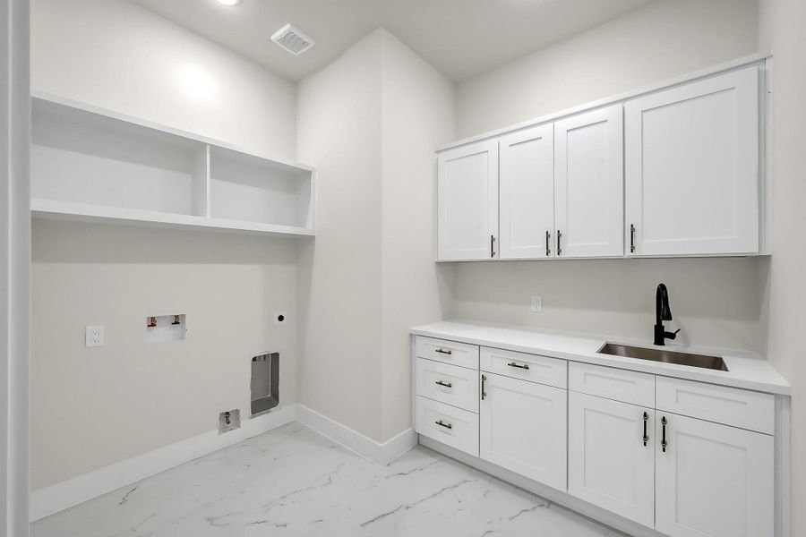 The large laundry room with ample storage makes laundry days a breeze.