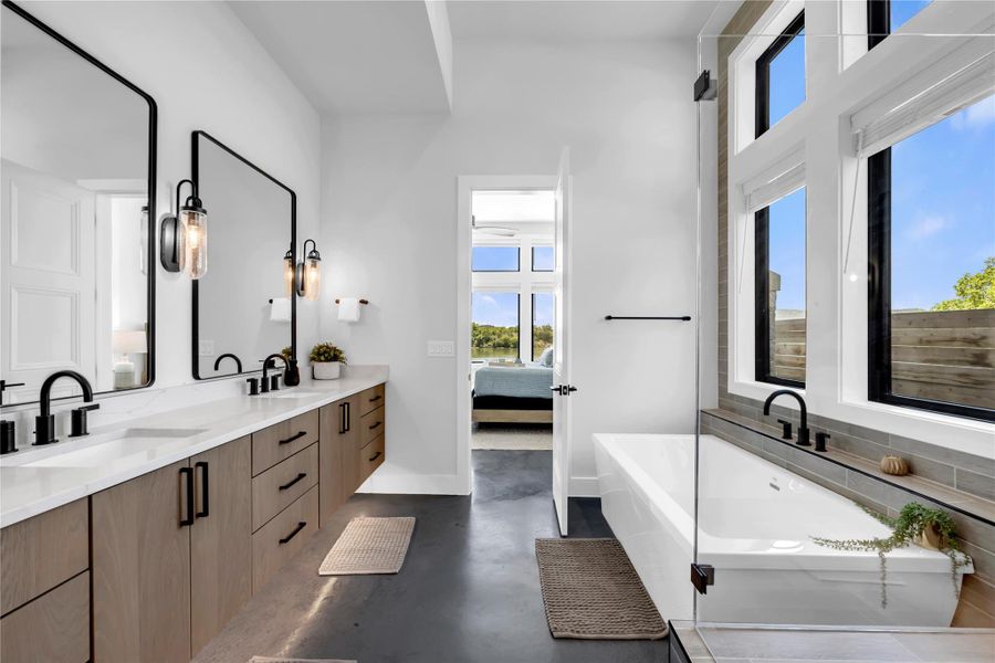 Contemporary bathroom featuring a dual vanity with wood-finish cabinetry and black hardware
