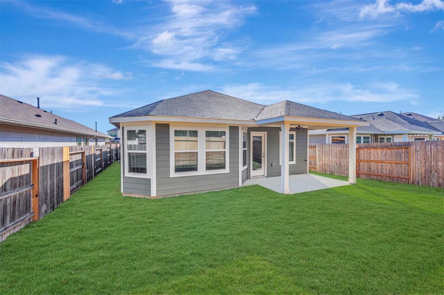Exterior details and patio area of a home in Pinewood at Grand Texas, New Caney (Image 30).
