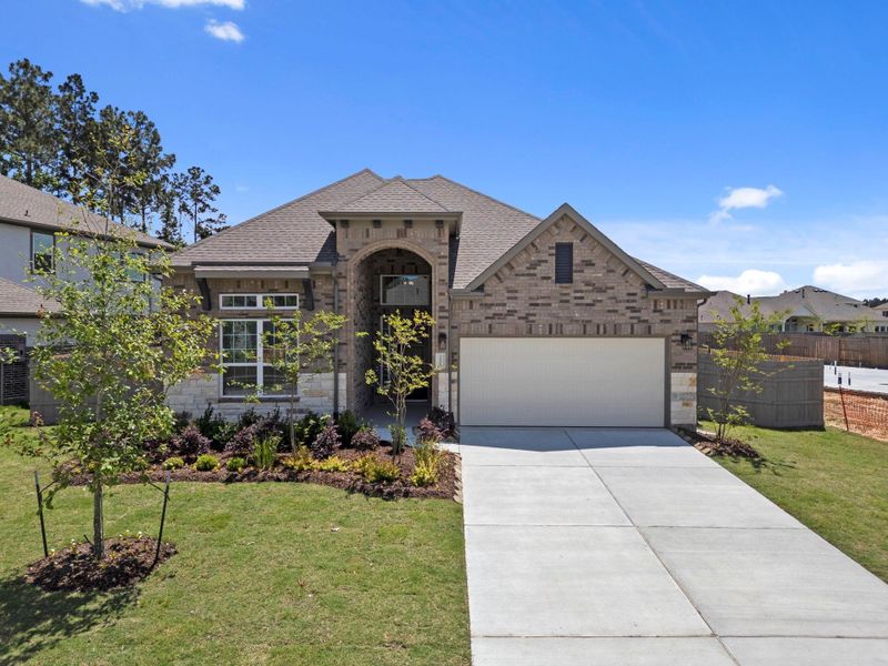 Front exterior of a new home in Artavia, Conroe, TX, highlighting curb appeal (Image 18).